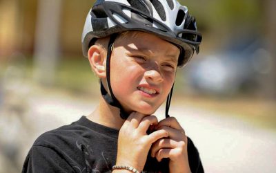 a-boy-secures-his-helmet-during-the-bicycle-safety-9a95f2-rev